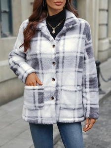 Detail view of plaid wool jacket featuring amber buttons and large front pockets