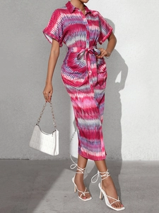 Detail of summer striped shirt dress featuring abstract print and matching waist tie
