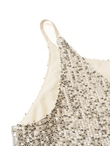 Close-up detail of champagne gold sequins on a sleeveless V-neck top with satin lining