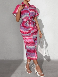 Detail of summer shirt dress featuring pink and blue geometric patterns with waist tie