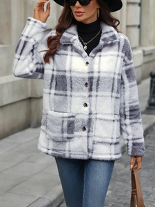Close-up detail of grey plaid wool coat texture and premium button closure