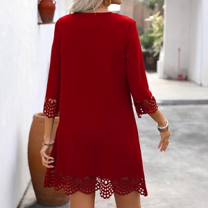 Back view of a red mini A-line dress with floral laser-cut hollow details and short sleeves