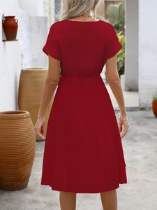 Detailed back view of a dark red short-sleeve dress with elegant pleated waist texture