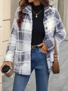 Close-up of thick plaid plush texture and button details on a grey checkered shacket