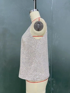 Macro side view of silver sequined sleeveless tank top with reflective round sequins