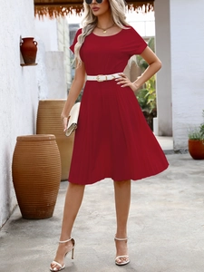 Detail of red pleated A-line dress with white waist belt and vertical pleats