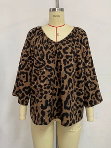 Detail of V-neckline and leopard print texture on casual chiffon blouse for women