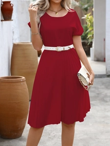 Detail of red short sleeve pleated dress featuring fine pleats and white slim waist belt