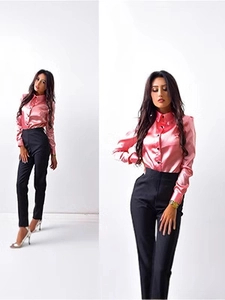 Detailed view of the pink satin shirt's sharp collar and contrasting dark button closure