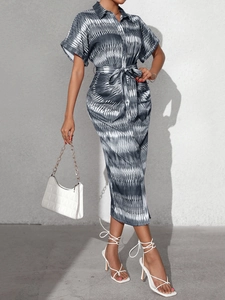 Detail of striped shirt dress with geometric ethnic print and waist tie belt