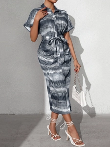 Detail of summer shirt dress featuring abstract wave print and waist tie-up belt