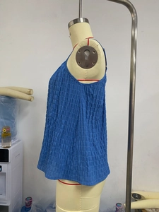 Detail view of blue sleeveless camisole top featuring pleated texture and relaxed fit style