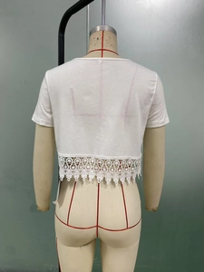 Detail of white cropped T-shirt featuring delicate crochet lace trim on the back hemline
