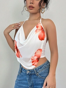 Detail of white halter top with orange floral print and elegant draped cowl neckline
