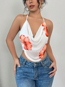 Close-up of cowl neck detail on white halter crop top with orange hibiscus print