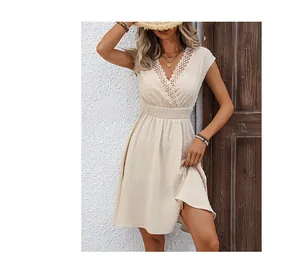 Close-up of V-neck lace patchwork and delicate Swiss dot texture on the ivory dress