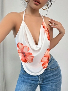 Detail of white halter neck top with red hibiscus floral print and draped V-neck design