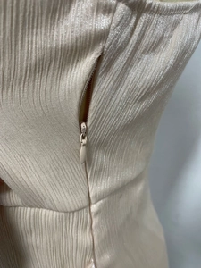 Detail von champagnerfarbenem Plissee-Stoff mit Glitzereffekt und unsichtbarem Reißverschluss