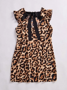 Detail of leopard print dress featuring a black satin bow tie and ruffle sleeve accents