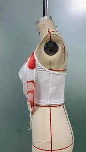 Detail of white halter crop top with red floral print on a side-view mannequin