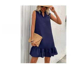 Detail of navy blue sleeveless dress with textured fabric and ruffled hemline