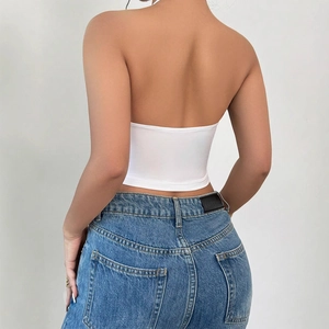 Sleeveless white halter neck crop top with open back design and neck tie detail