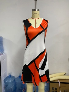 Detail of the V-neckline and orange geometric plaid print on this sleeveless summer dress