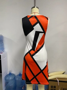Detail of color-block geometric sleeveless dress with orange, black and white panels