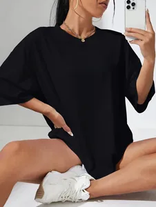 Detail of loose black oversized T-shirt with bold white WHY NOT text print