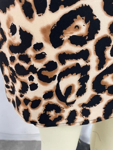 Detailed view of leopard print dress hem with high-quality flat seam edge stitching