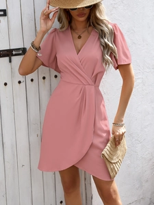 Close-up of elegant pink short sleeve dress with wrap V-neck and pleated waist details