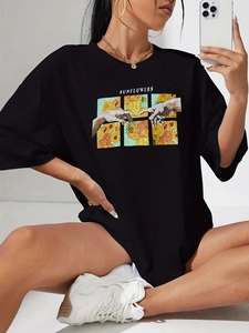 Detail of loose fit black crewneck t-shirt with sunflower and hands artistic graphic print