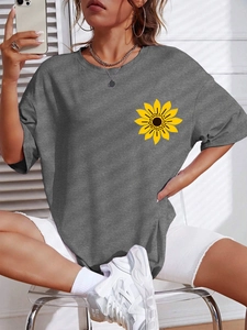 Detail of dark grey loose-fit cotton T-shirt featuring a yellow sunflower print on chest