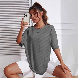 Detail of dark grey oversized T-shirt with drop shoulders and a relaxed urban fit
