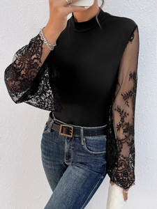 Detail of elegant black sheer lace sleeves with floral embroidery on a slim bodysuit