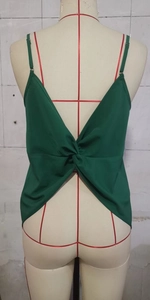 Detailed back view of a dark green backless camisole featuring a unique twisted knot design