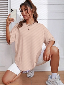 Detail of oversized crew neck short sleeve T-shirt in apricot with dropped shoulders