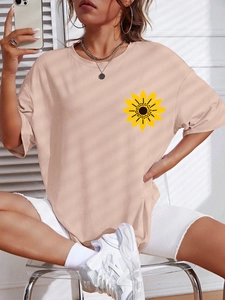 Detail of apricot short sleeve t-shirt with sunflower print and ribbed crew neck finish