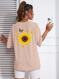 Detailed back view of oversized t-shirt with sunflower and butterfly graphic print
