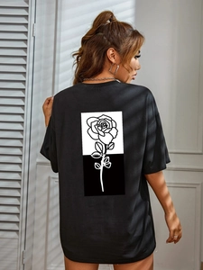 Women's black oversized T-shirt featuring a large black and white rose print on the back