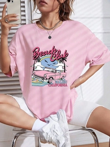 Close-up of pink oversized cotton T-shirt featuring a retro Malibu Beach Club car print