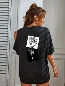 Women's oversized black t-shirt with rose print on back and artistic window lighting