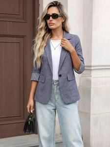 Detail of grey-blue women blazer with striped cuff lining and single button closure