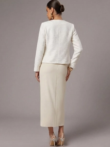 Rear 45-degree view of elegant white tweed jacket paired with a beige long skirt
