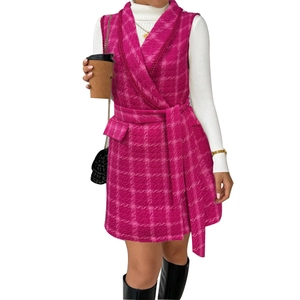 Pink plaid tweed vest with belt paired over a white ribbed turtleneck sweater