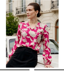 Detail of floral V-neck long sleeve blouse with elegant elastic cuffs on a street shoot