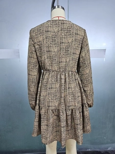 Detail view of long-sleeve dress with high-waist pleats and tiered ruffle hemline