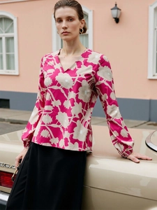 Close-up of V-neck rose red floral print shirt with elegant lantern sleeves in street style