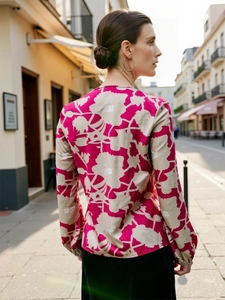 Detail of rose red long sleeve floral blouse showing chiffon texture and cuff pleats