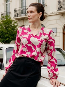 Detail of floral V-neck long sleeve blouse with elegant beige flower pattern for women